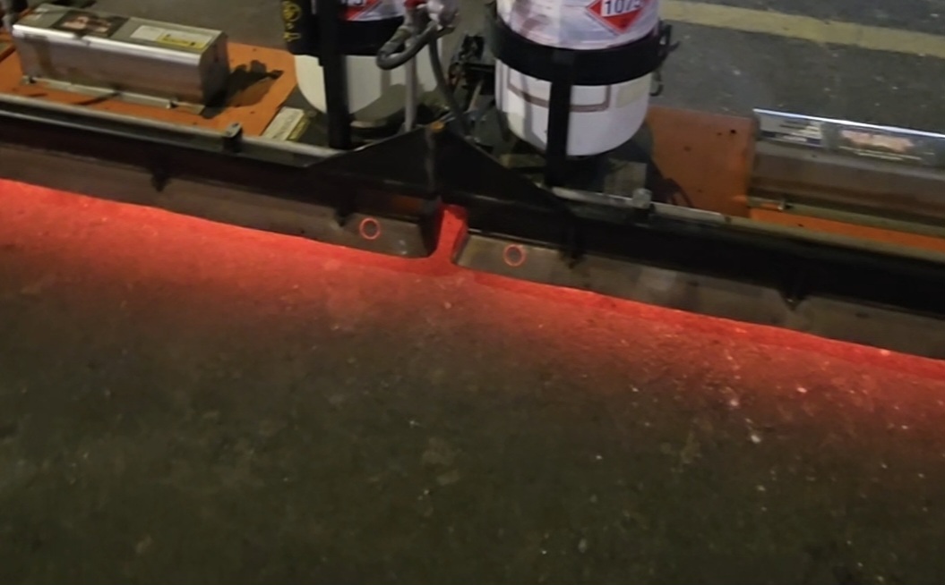 HDE infrared heater glowing red on asphalt