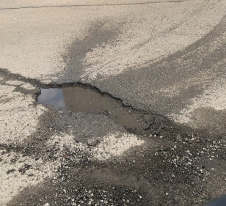 Pothole before — water pooling